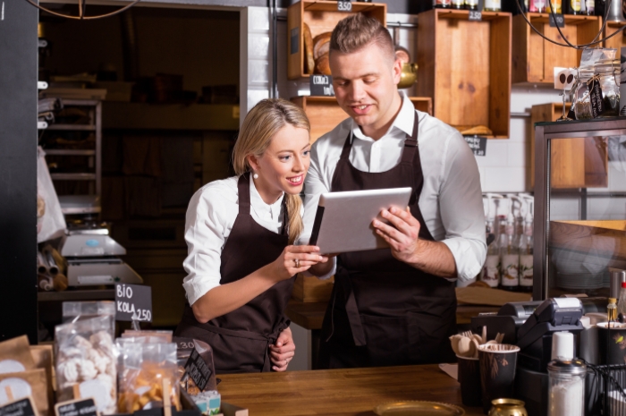 Business owners look at a tablet