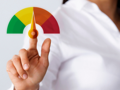 Person in white shirt pointing to credit score gauge